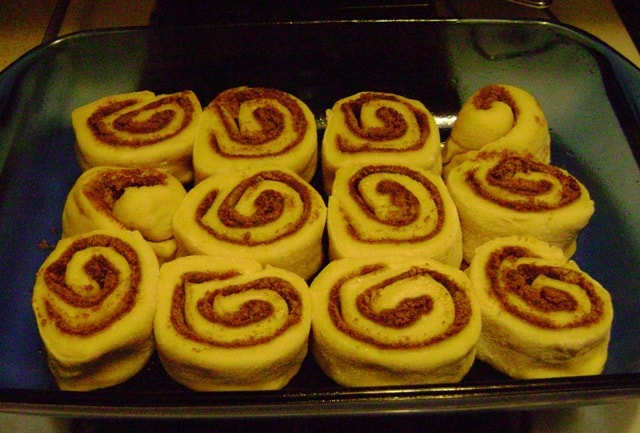 alton brown's overnight cinnamon rolls, unbaked, face up in a pan