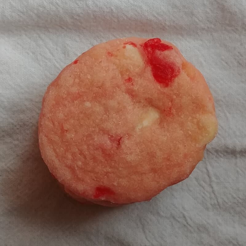 a white chocolate cherry shortbread cookie on a white background