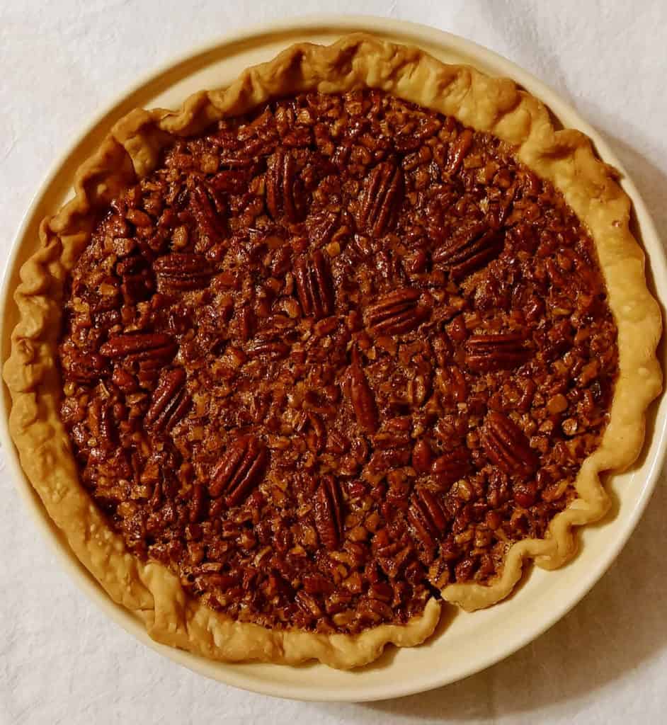 A whole Pecan Pie in a ceramic pie plate