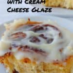 cinnamon rolls with cream cheese glaze, on plates - pin for Pinterest