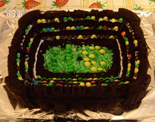 chocolate stadium cake decorated with coconut and M&Ms