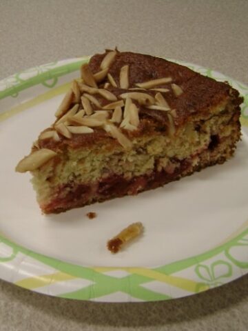 a slice of cherry-almond coffee cake on a plate