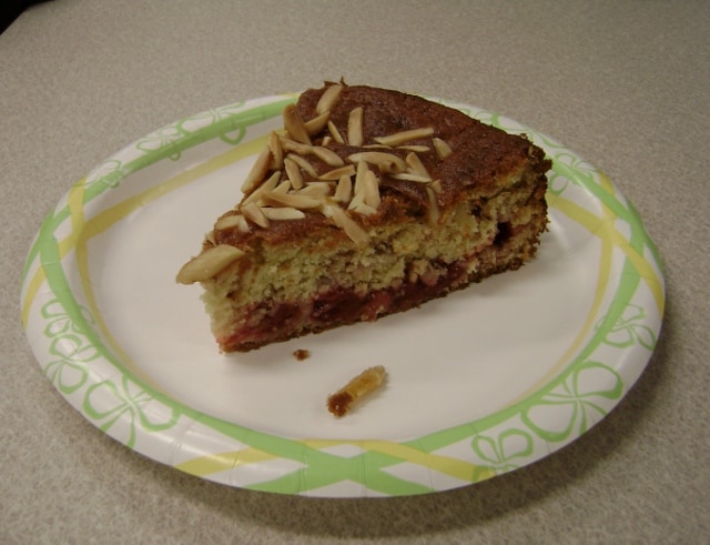a slice of cherry-almond coffee cake on a plate
