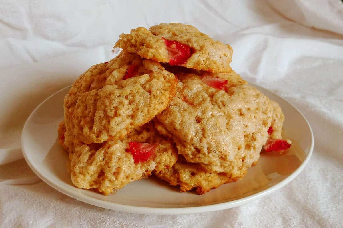 a plate filled with strawberry and cream scones