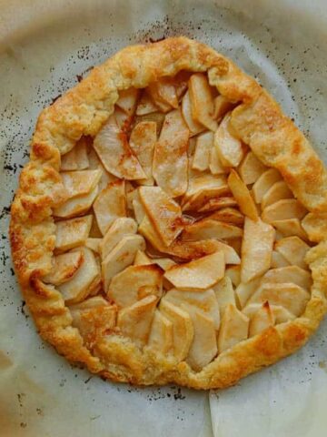 a whole apple galette, baked on parchment paper