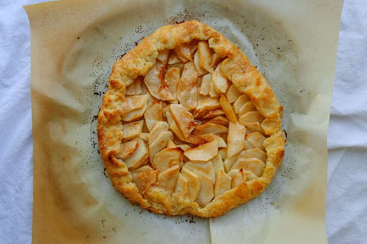 a whole apple galette, baked on parchment paper
