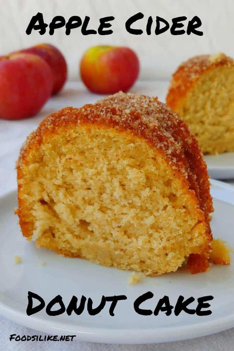 slices of apple cider donut cake, with apples in the background - pin for pinterest