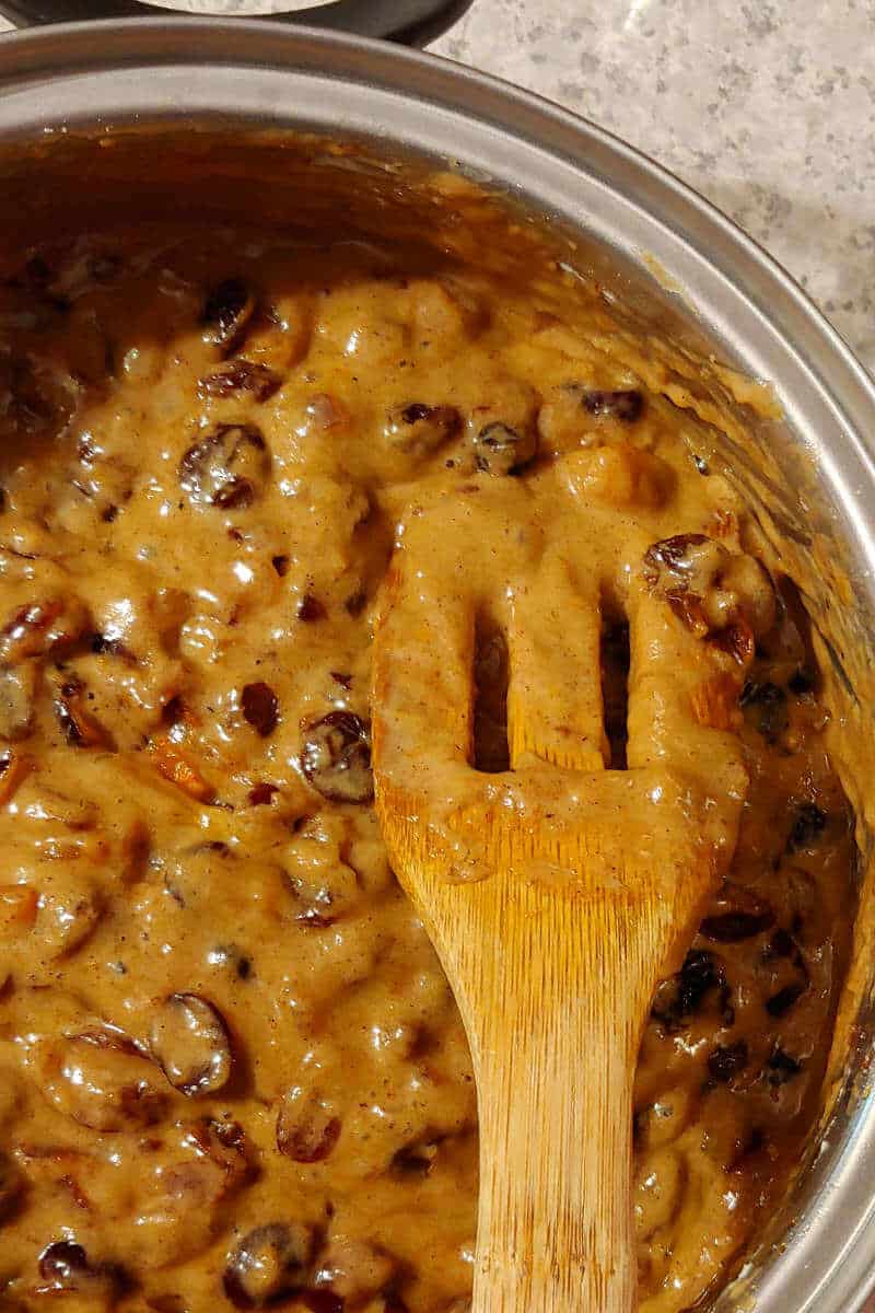 batter for Alton Brown's fruitcake, in a saucepan with a wooden spoon