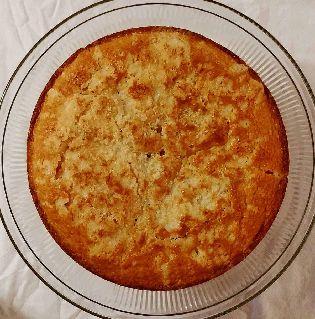 Cranberry Vanilla Coffee Cake, on a cake plate, seen from overhead