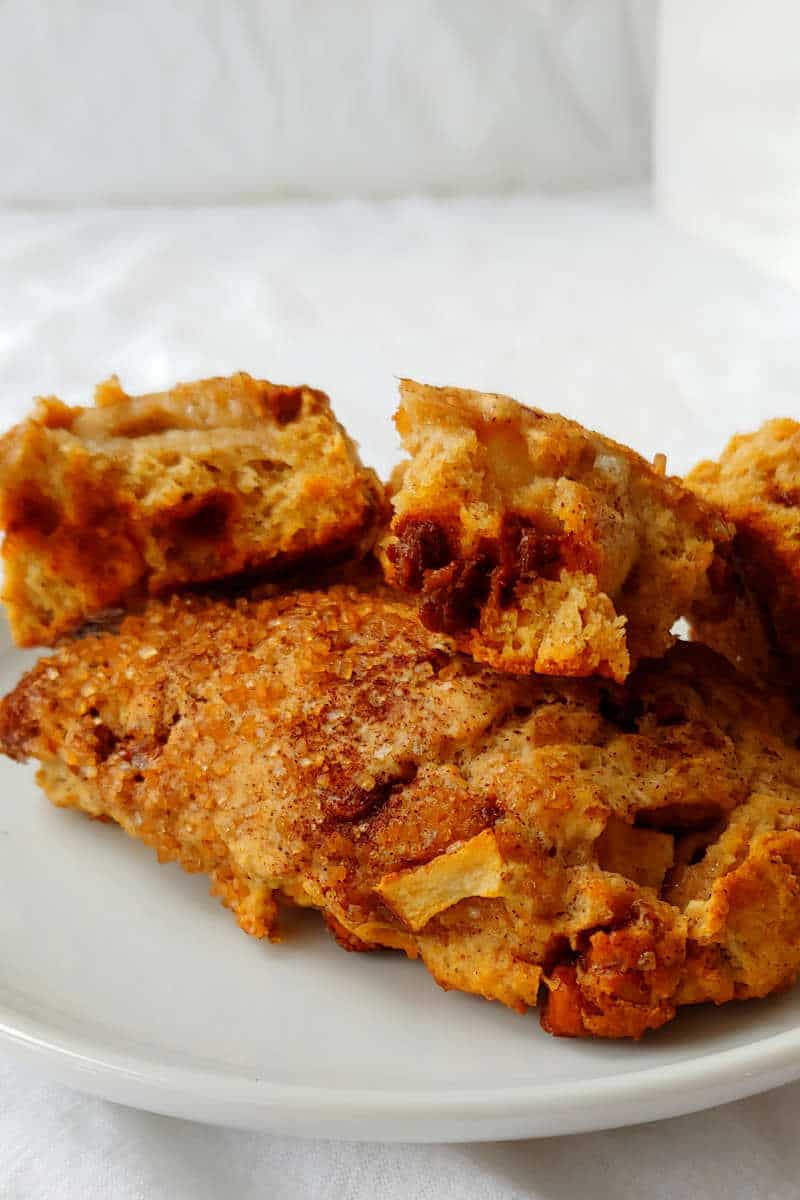 fresh apple cinnamon scones, on a plate, with one of them split open