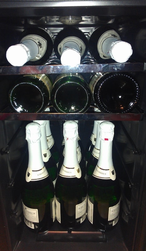 a wine fridge full of sparkling wine