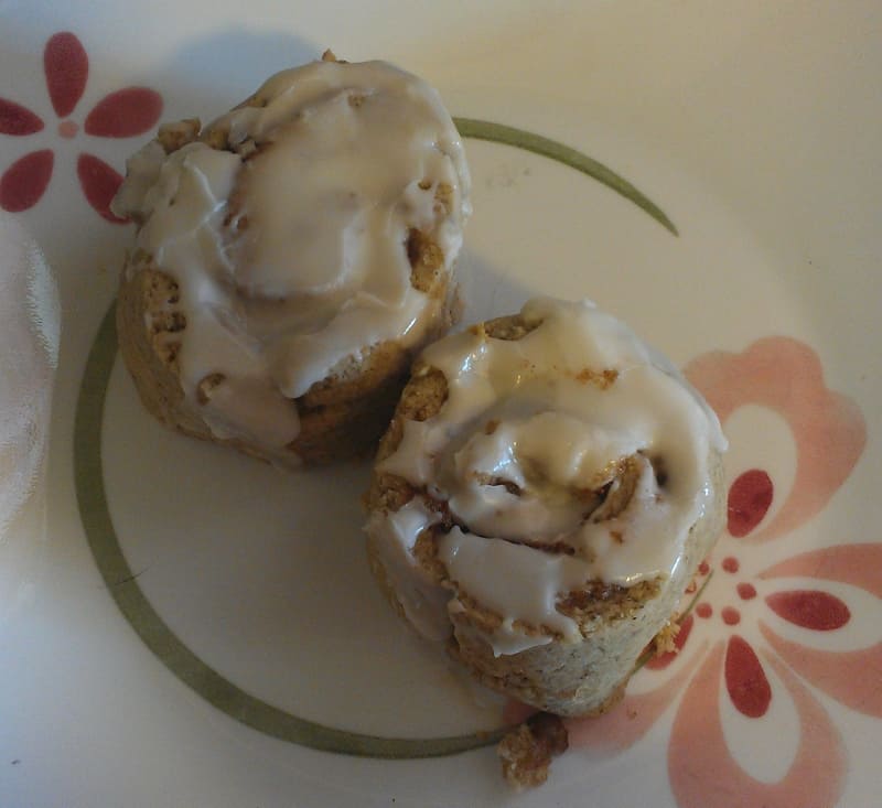 gluten-free cinnamon rolls, glazed and on a plate