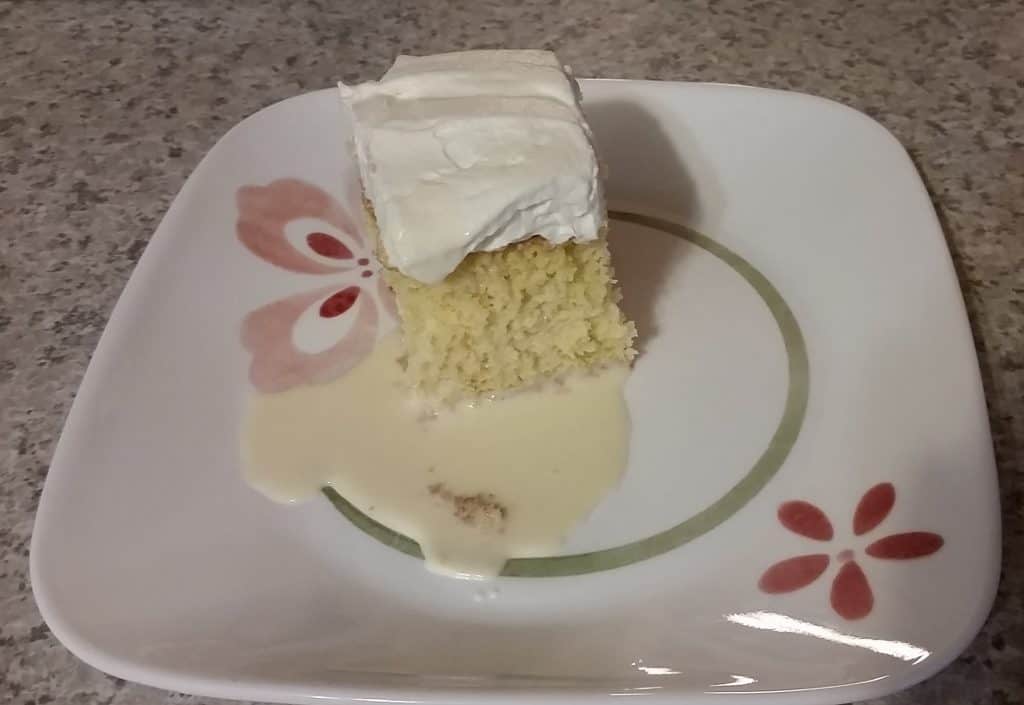 a slice of tres leches cake, on a plate