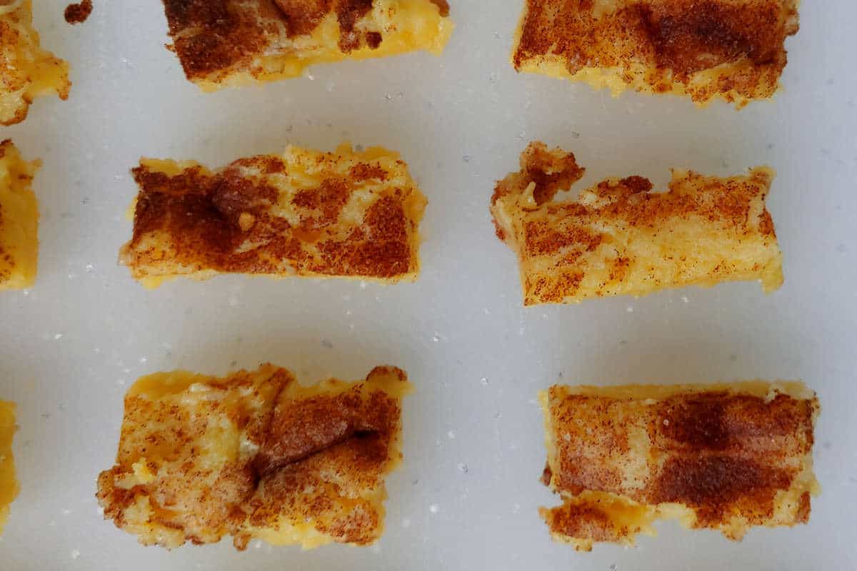 cinnamon gooey butter cake bars, lined up in rows
