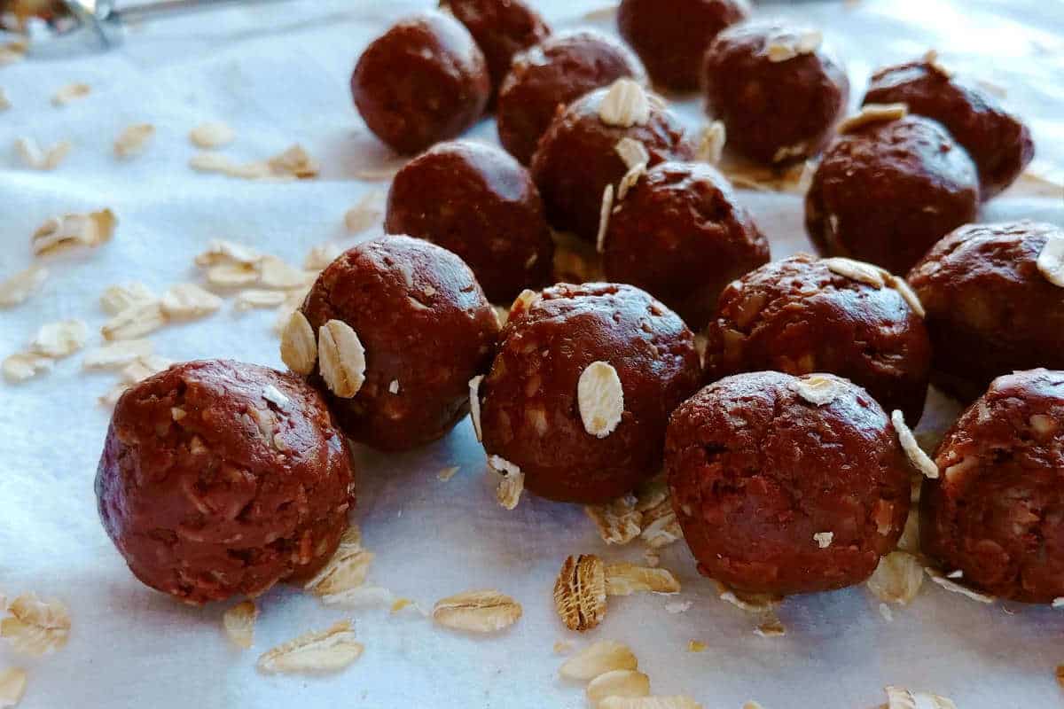 chocolate peanut butter bites, sprinkled with oats, on a tablecloth