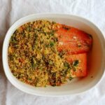 salmon with baked couscous, with salmon only half covered by couscous before it goes in the oven