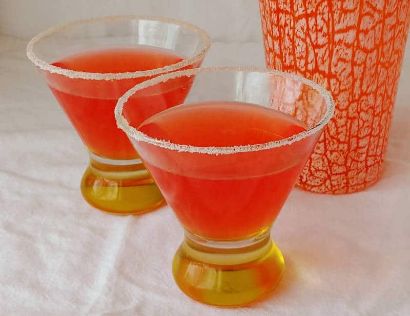 two campari margaritas in glasses lined with sugar
