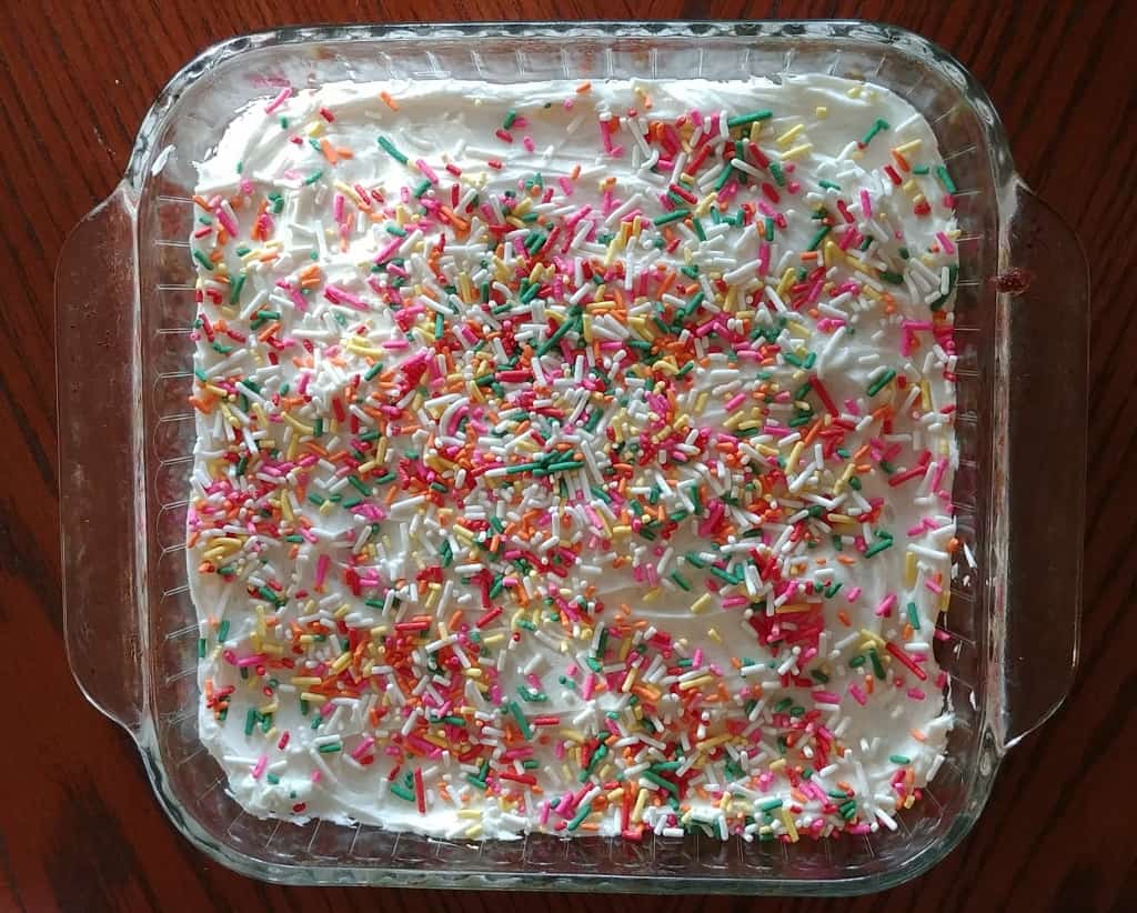 a whole confetti cake with sprinkles, in a baking dish