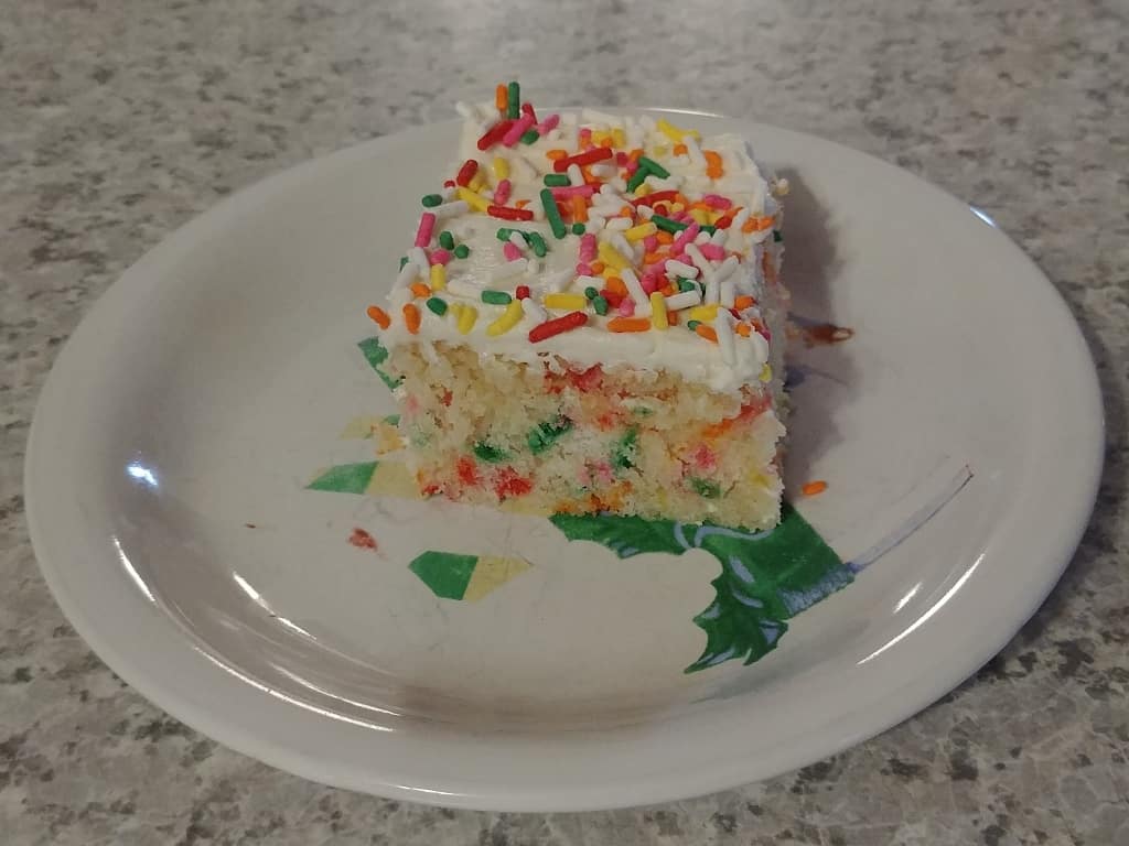 a slice of confetti cake on a plate