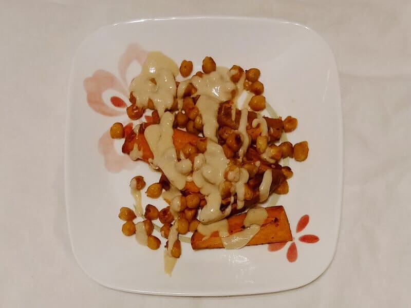 roasted chickpeas with sweet potatoes, topped with tahini lime sauce