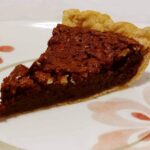 a slice of pecan fudge pie