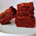 alton brown's plain ole' brownies, stacked on a plate