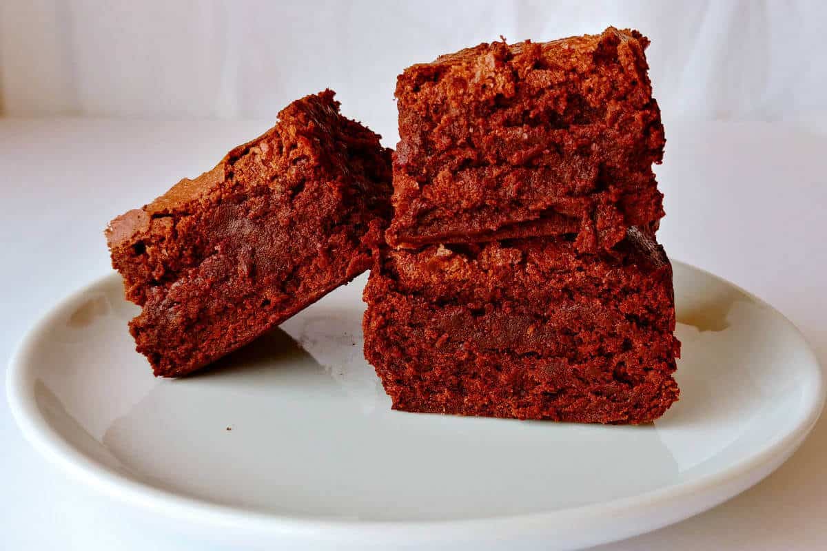 alton brown's plain ole' brownies, stacked on a plate