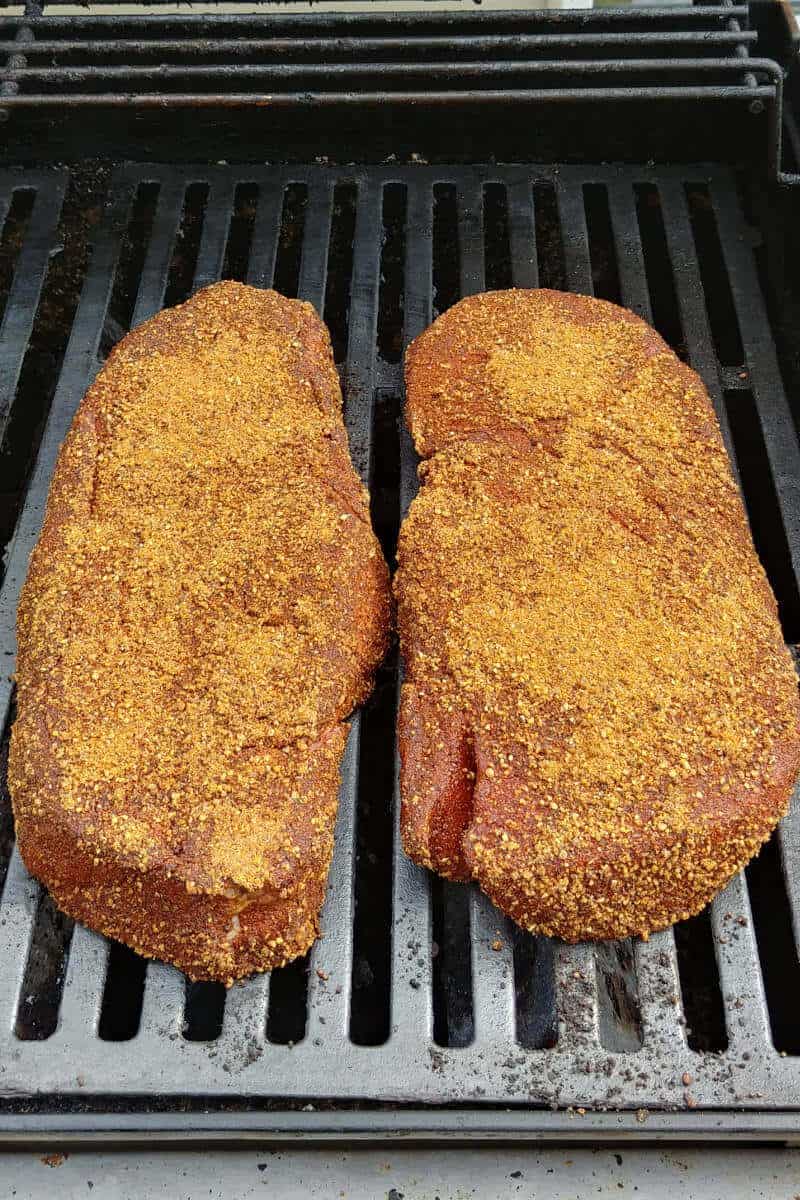 steak, on a grill, rubbed liberally with barbecue spice rub