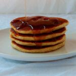 a stack of 4 easy pancakes, with syrup being drizzled over the top