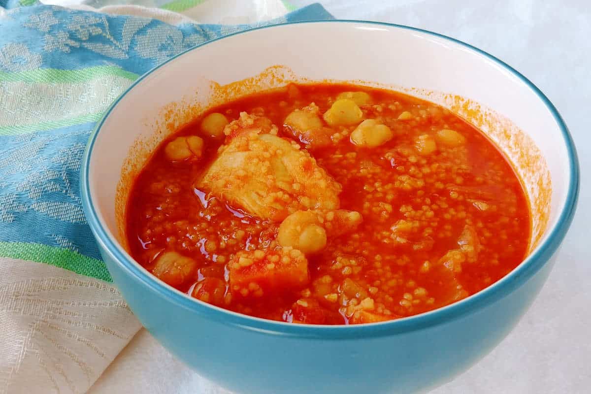 stewed chicken and chickpeas, with couscous, in a bowl on a table