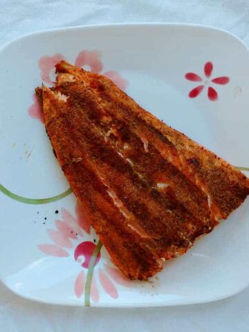 fennel spice rub on grilled salmon, on a plate