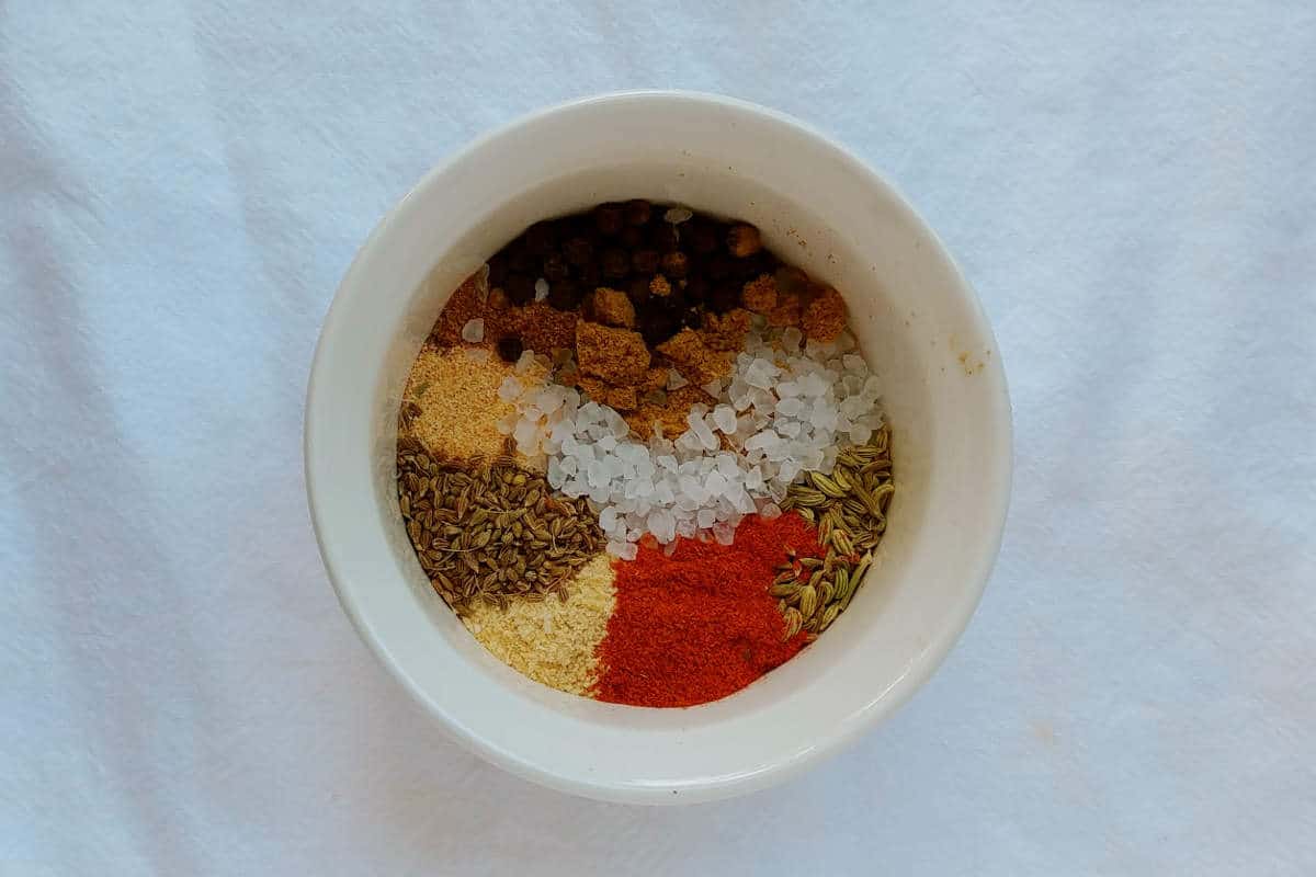 spices in a bowl for fennel spice rub - fennel, coriander, cumin, anise, cayenne, black pepper, garlic powder, and salt