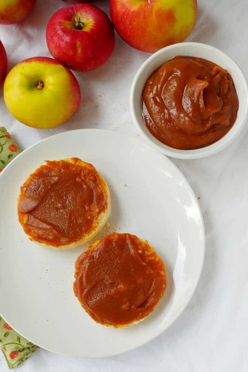 slow cooker apple butter with no sugar added, in a bowl and spread on English muffins