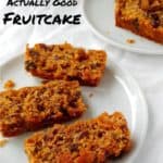 alton brown's fruitcake, slices on plates, with a bottle in the background - pin for Pinterest