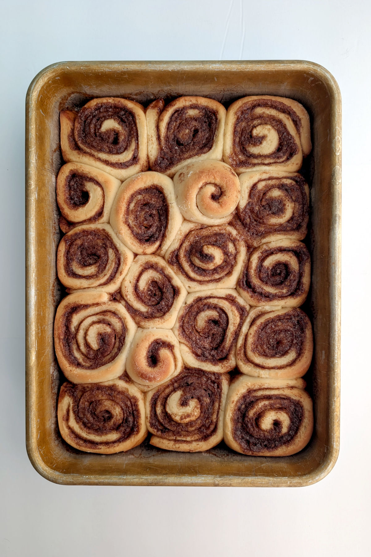 Cinnamon rolls baked in a 9x13 inch pan.