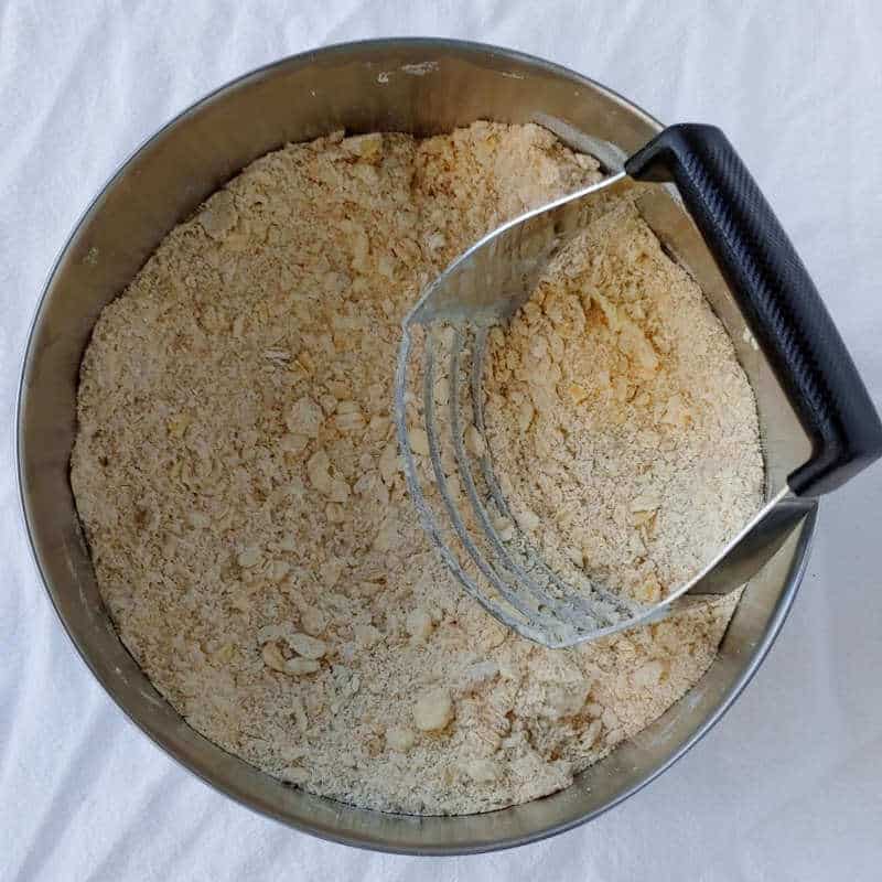 dry ingredients for cranberry oat pecan scones, with butter cut in