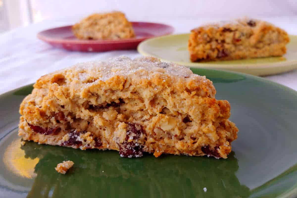 cranberry oat pecan scones, on three red and green plates