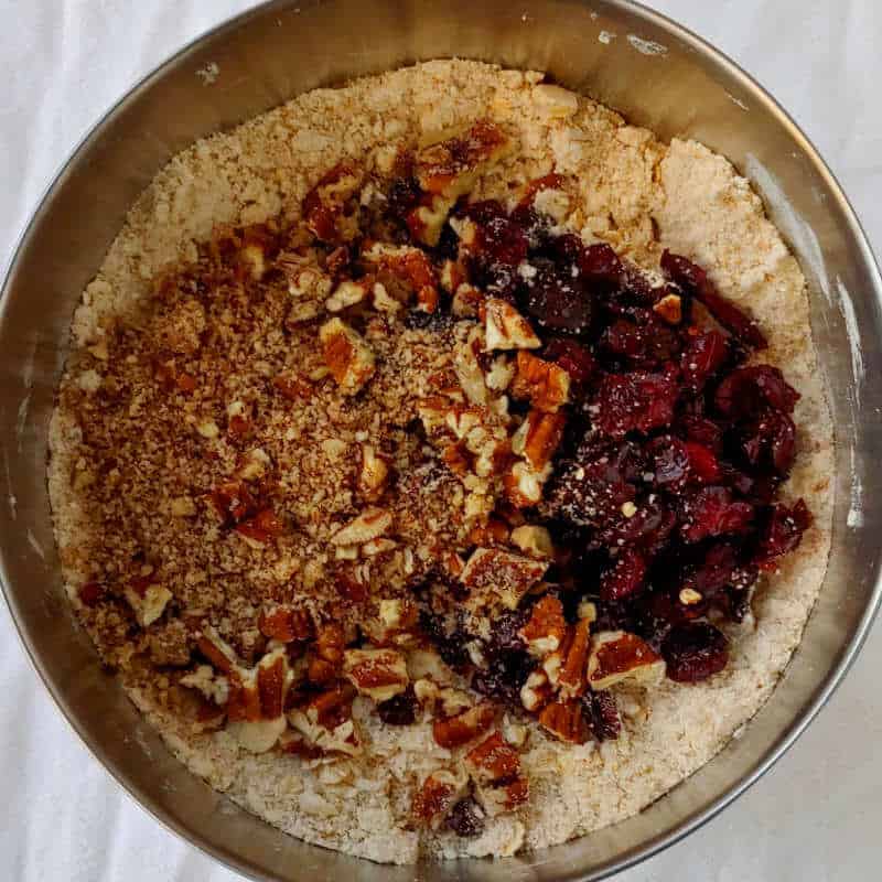 dry ingredients for cranberry oat pecan scones, with cranberries and pecans added