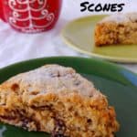 cranberry oat pecan scones, on plates, with a red Christmas mug in the background - pin for Pinterest