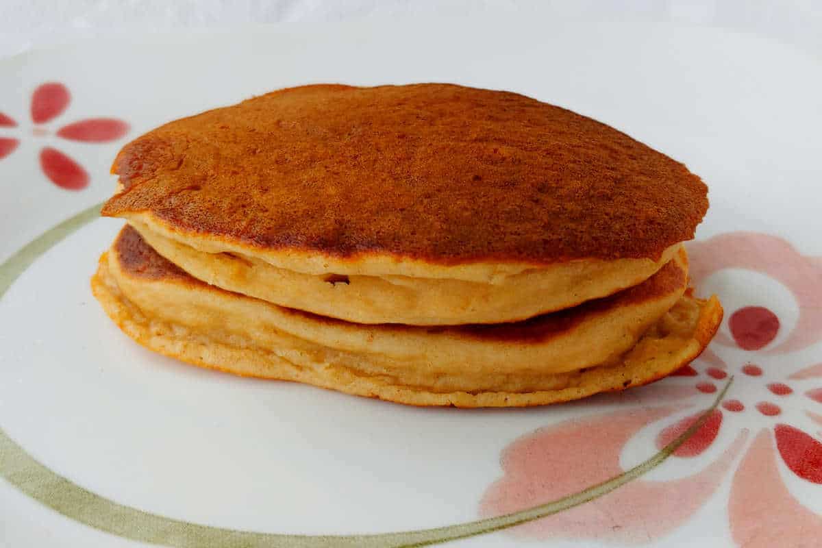 pancakes, stacked on a plate, after being gently reheated in a microwave from frozen