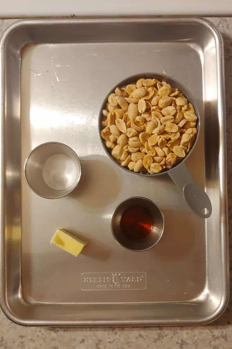 peanuts, butter, baking soda, and vanilla extract, laid out on a baking sheet for microwave peanut brittle