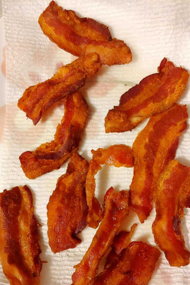 bacon, fried and draining on a paper towel