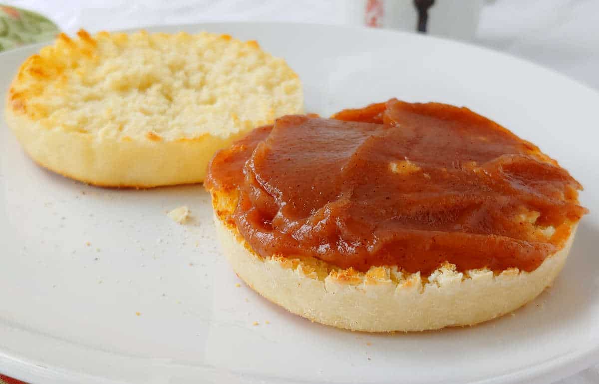 an english muffin, split and toasted, with apple butter on one half