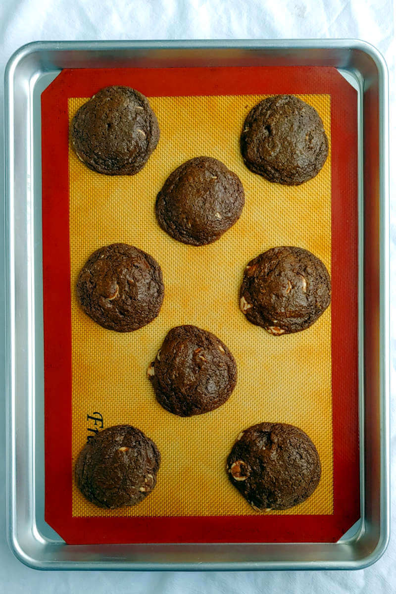 double chocolate caramel chip cookies, on a baking sheet, right from the oven
