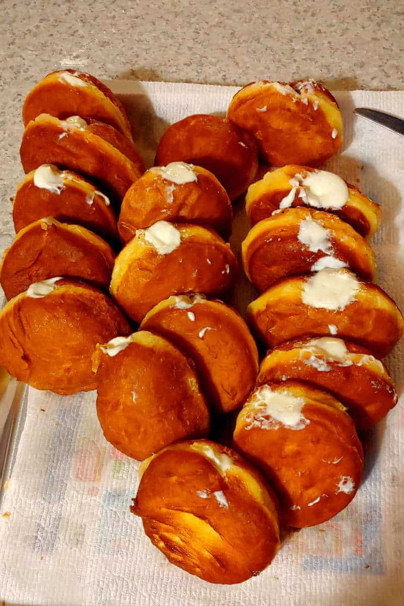 filled paczkis, in rows on a plate