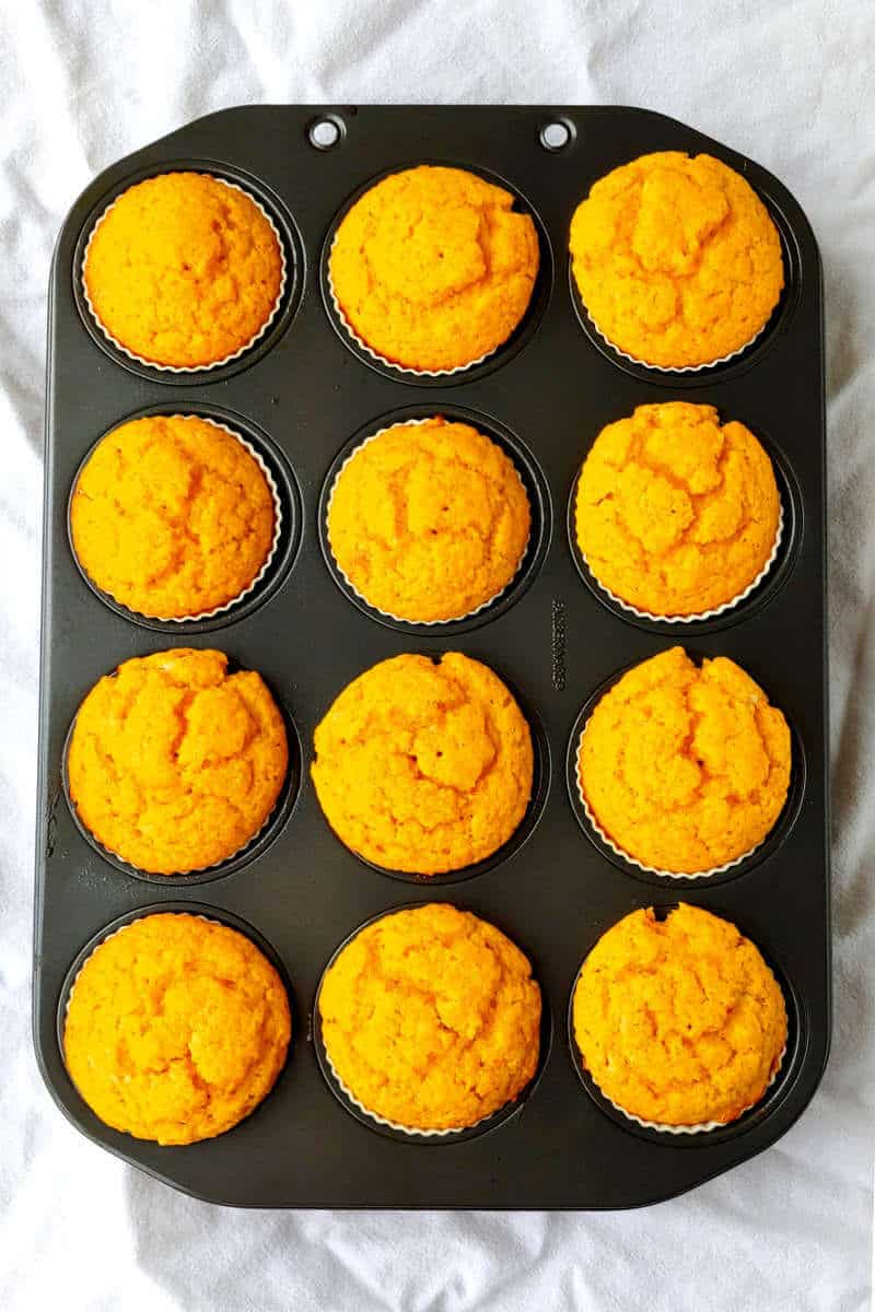 orange cupcakes, baked, in a muffin tin