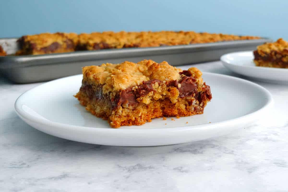 chocolate oat bar, on a plate in front of the baking pan