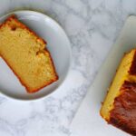 a slice of ricotta pound cake beside the loaf