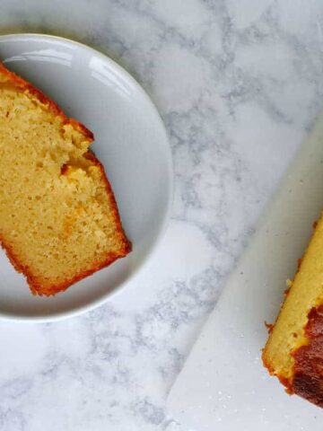 a slice of ricotta pound cake beside the loaf