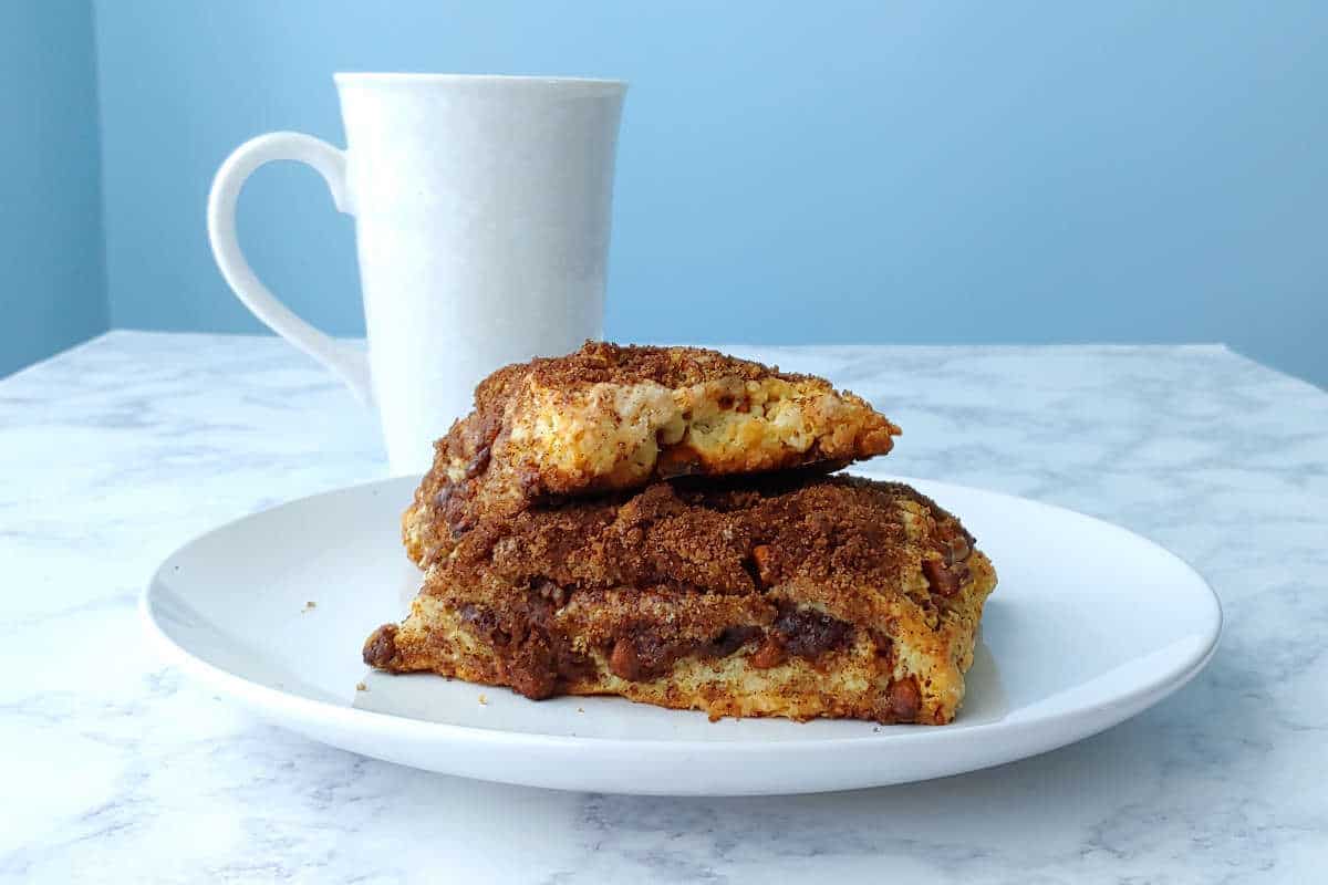 triple cinnamon scones, on a plate, with a mug of coffee